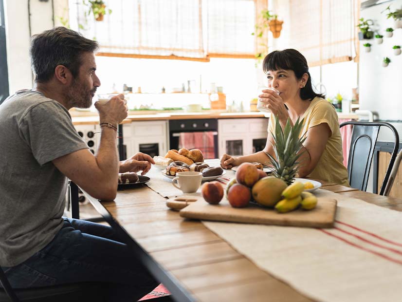 Two people sitting at table and drinking water